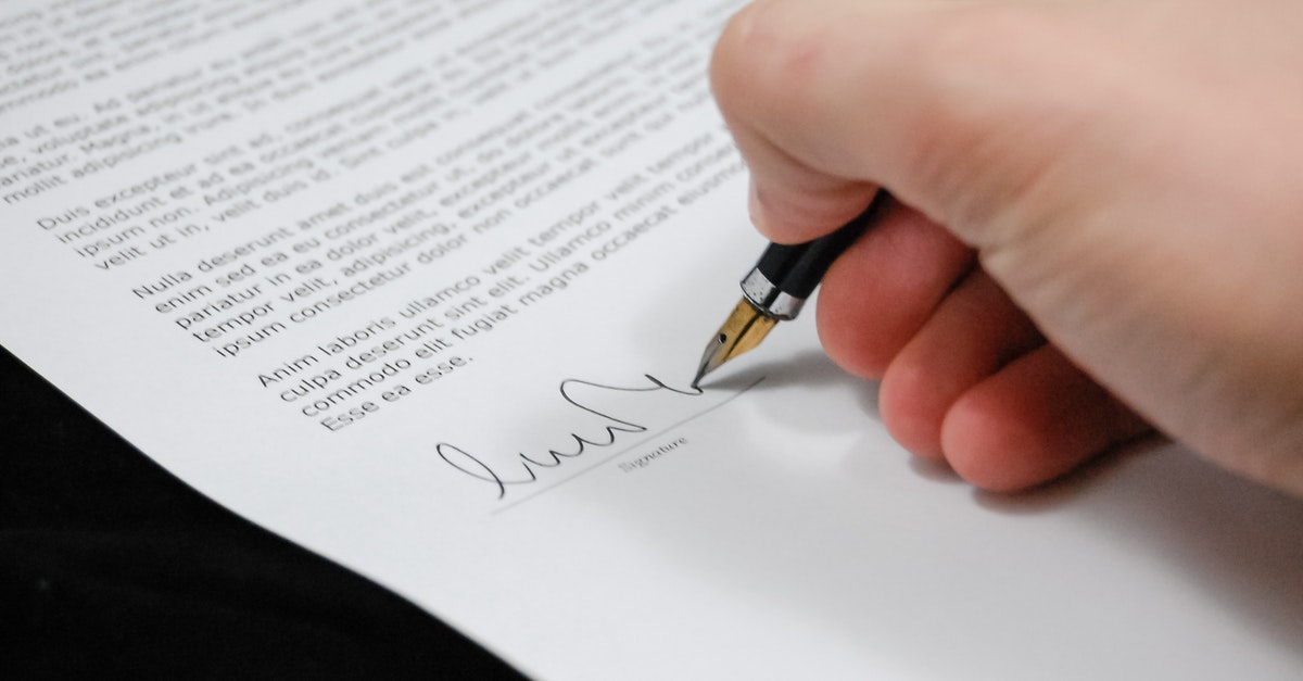Person signing signature on document