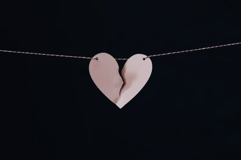 Paper heart breaking hanging on string