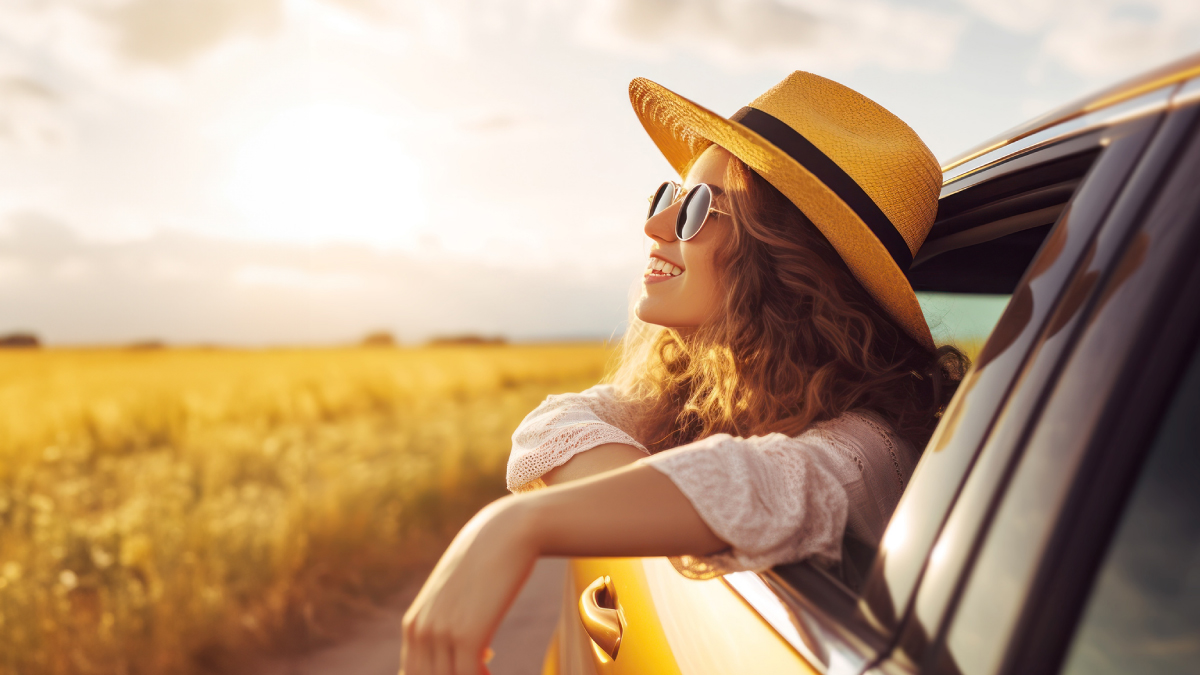 Woman riding a car looking at the fields