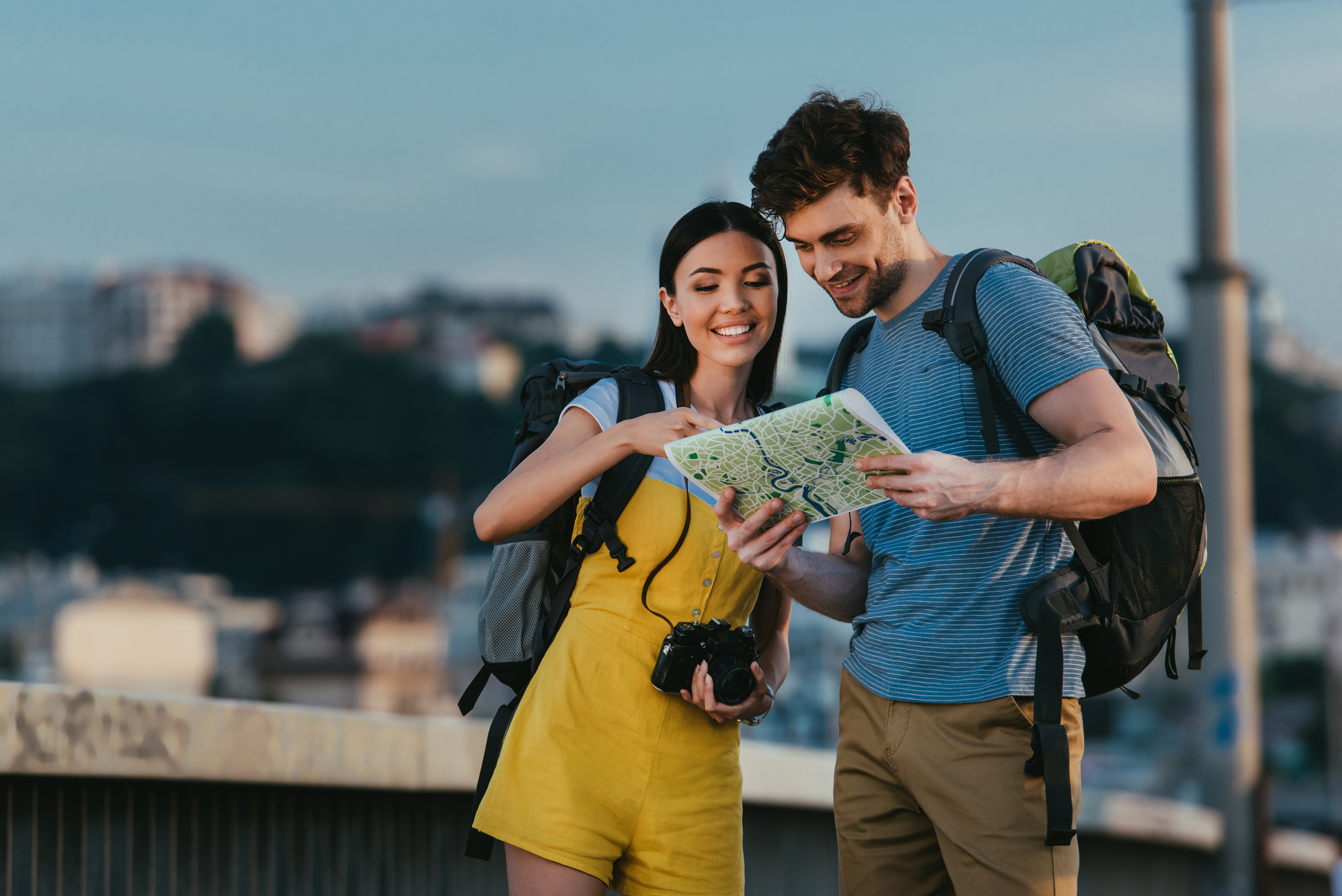 Man and woman smiling looking at the map