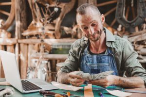 business success artist male leather handcraft worker sale master piece products earn money