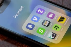 Portland, OR, USA - Apr 27, 2025: Assorted apps to send money, including PayPal, Venmo, Zelle, Cash App, Apple Cash, Skrill, Splitwise, Wise, and Western Union, are seen on the screen of an iPhone.